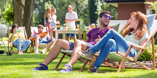 opens in a new tab group of young adults having a party in the backyard